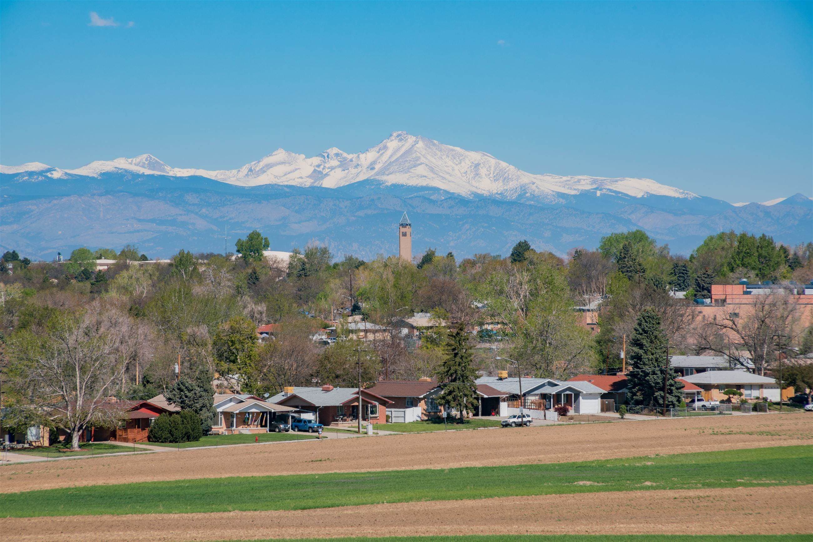 Snowcapped Front Range peaks rising above a Colorado neighborhood