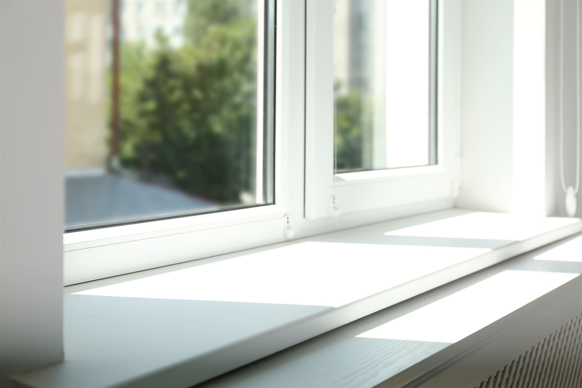 Sunlight falling across a clean white window sill